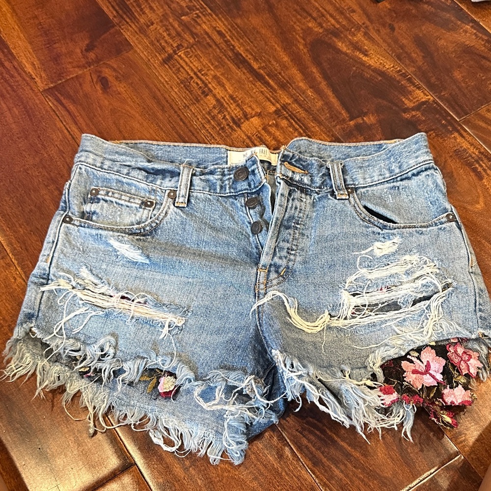 Free People Distressed Denim Shorts with Floral Accents